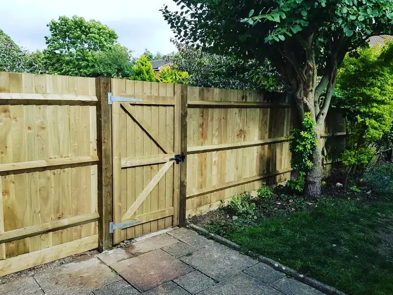 Closeboard timber fence with a braced timber gate, finished by Worcestershire Fencing